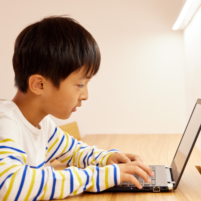 オンライン授業でプログラミングを学習する子供